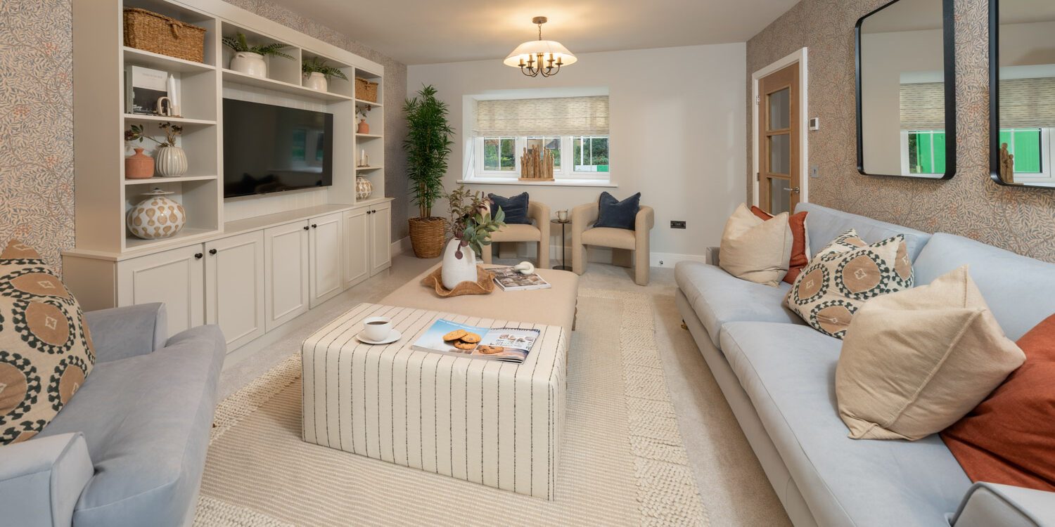 Living room with grey sofa, cream carpet and wall recess tv